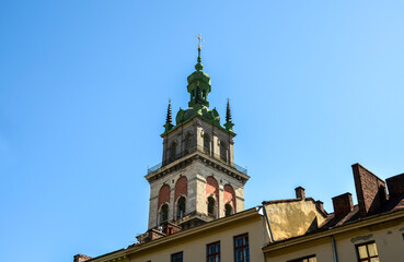 Tall, historic Kornyakt Tower, which is part of the Assumption Church with a distinct green spire...