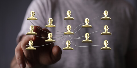 Hand touching digital network with golden icons. Concept of business, teamwork, connection, community, and digital transformation.