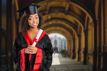 Happy joyful graduates students in caps and gowns