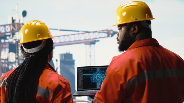 Offshore platform team using deep learning software on laptop to optimize drilling operations. Computer scientists on drilling rig ship analyzing geology data using AI technology