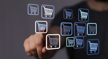 Person interacting with virtual shopping cart symbols, representing online purchasing, e-commerce, and digital retail. Perfect for illustrating