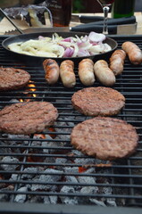 meat cooking in the garden on a barbecue, tasty summer food outdoors 