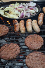 meat cooking in the garden on a barbecue, tasty summer food outdoors 