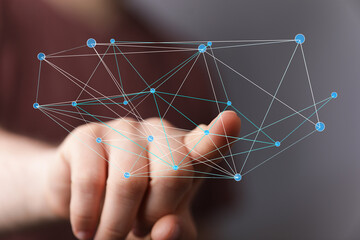 Concept of connection and networking with hand interacting with a digital network, representing the global web, AI, and modern technology.