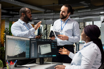 Team of engineers brainstorming upgrades for solar gadget to support green technology adoption....