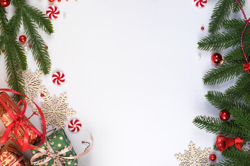 Vertical Christmas frame with gifts and fir branches on white background with copy space
