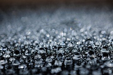 macro close-up of water droplets on a dark background. Mockup for your logo. horizontal wallpaper or web banner.