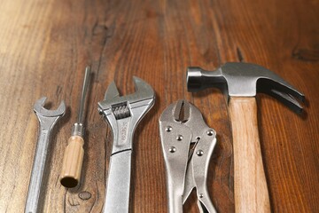 hammer hand tool on wooden background