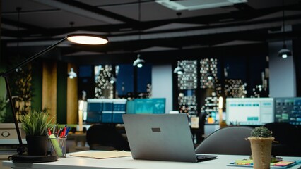 High end empty office features laptop and monitors for forecasting. Modern space set for corporate...
