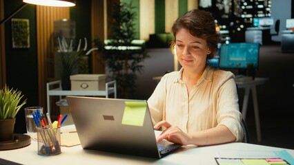 Female employee proofreading a document before transcribing on notebook, handwritten notes on paper after hours. Woman engaged in documenting important ideas from archived report. Camera A.
