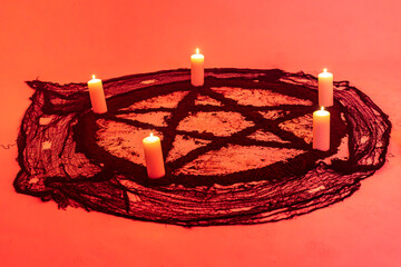 Images of red and black pentagrams representing mystical and esoteric symbols linked to...