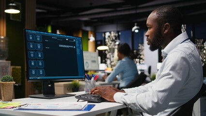 African american male checking web AI chatbot responses for some tasks, working after hours to meet business objectives. Problem solving with futuristic tech and machine learning.