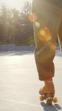 Roller skaters feet gliding across bright plaza at golden hour