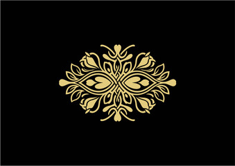 Ornate gold floral design with symmetrical elements on a black background, creating an elegant decorative motif.