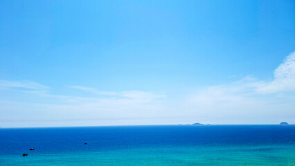 Vast Expanse Of Bright Blue Sky Meeting The Tranquil Turquoise Ocean On A Clear Sunny Day