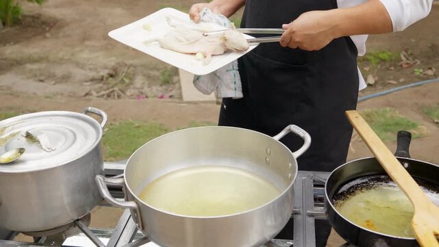 Chef frying guinea pig in hot oil for peruvian dish