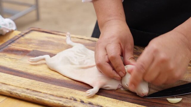 Peruvian chef preparing cuy, a traditional guinea pig dish