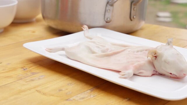 Preparing traditional peruvian cuy dish with fresh vegetables