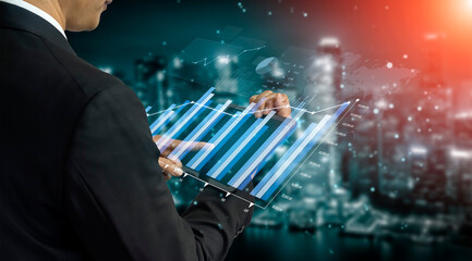A businessman in a suit is interacting with a digital tablet, analyzing financial growth data visualized through graphs, set against a vibrant urban skyline at night. Scalp