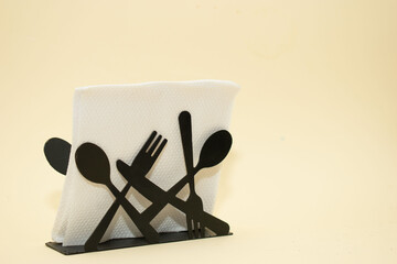 Black metal cutlery holder on beige background