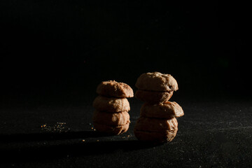 Stack of small cookies on dark background