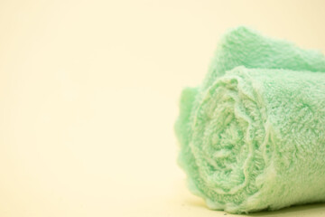 Rolled mint green towel for spa use
