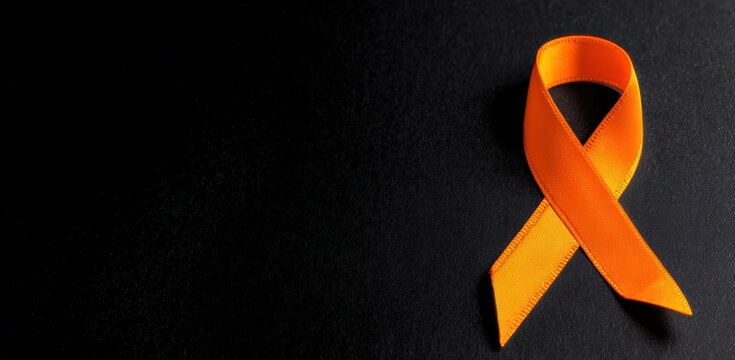 Orange ribbon representing awareness for conditions like leukemia, multiple sclerosis, and kidney cancer, set against a dark background