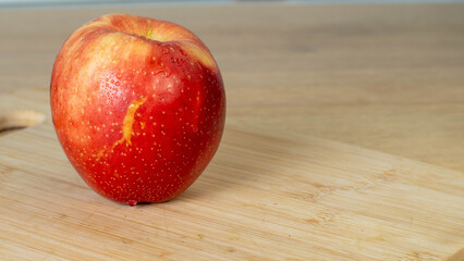 red apple on wooden table