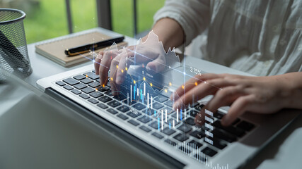 A professional person engaged in data analysis using a laptop with graphic charts displayed on screen, illustrating modern technology and creative workspace. Scalp
