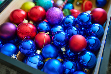 Box of Christmas ornaments filled with bright and colorful Christmas balls to hang from the tree