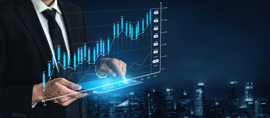 A businessman uses a tablet to analyze financial data while viewing success graphs, set against a stunning city skyline at night. A blend of technology and progress. Scalp
