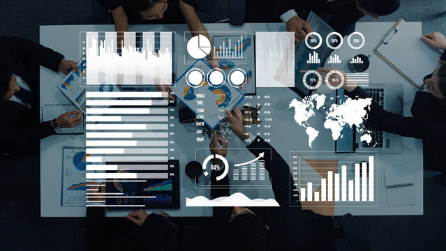 A diverse group of professionals collaborates in a modern office, utilizing data visualization tools for financial analysis and strategic planning. Axiom - Powered by Adobe