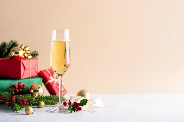 Festive champagne glass with christmas gifts and elegant holiday decorations
