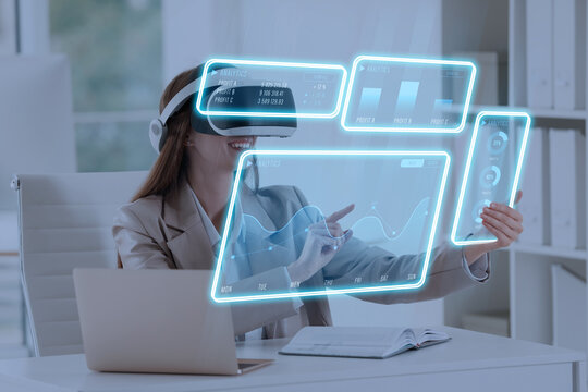 Woman using digital screen with data via virtual reality headset in office. Innovative technology for business