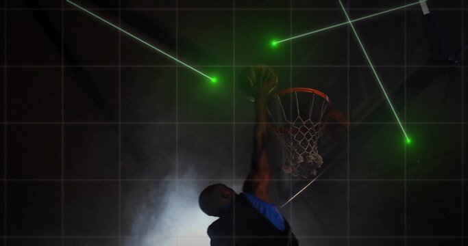 Jumping basketball player in blue jersey executing dunk in court, with green lasers gridlines smoke