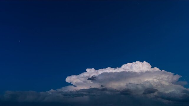 Dusk light fading behind cumulonimbus tower lightning flashes 