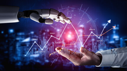 A robotic hand extends toward a human hand against a backdrop of digital financial graphs,...