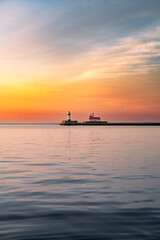 Fototapeta premium Peaceful Sunrise Over Lighthouse and Harbor