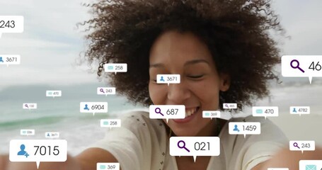 Creator raising smartphone on beach summoning social media metrics demonstrating engagement growth - Powered by Adobe