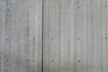 Grey concrete wall with vertical line texture
