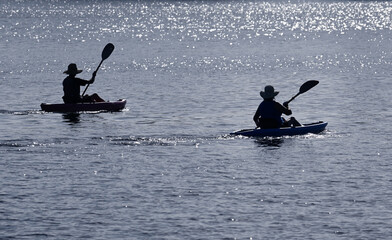 Retired active senior Australian couple kayaking together