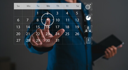 A person interacts with a digital calendar, highlighting a date, showcasing technology's role in...