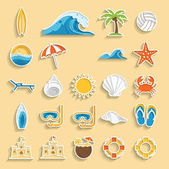 Various summer beach items are arranged neatly on a sandy surface, evoking a sense of relaxation and vacation fun.
