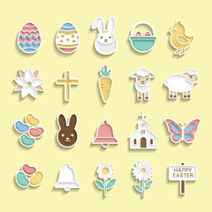 Easter themed objects arranged on yellow surface representing springtime celebration with religious and secular symbols.