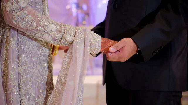 Bride and groom Mehndi holding each others hands during Wedding Photoshoot 