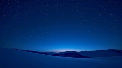 Fototapeta premium Tranquil Winter Night Landscape: Snow Fields and Mountains Beneath a Deep Blue Star-Filled Sky