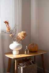 autumn decor arrangement, ceramic vase with autumne leaves and branches, pumpkin setup with...