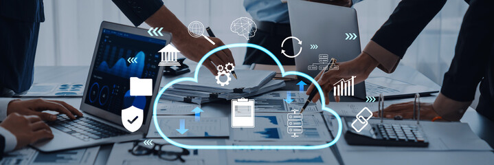 A team collaborates on cloud technology solutions in a modern office, surrounded by digital icons representing data analysis and connectivity for improved productivity. Trope