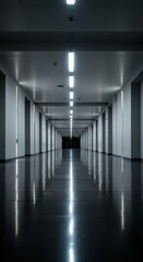 Fototapeta premium A long, empty corridor with polished floors creating a strong, symmetrical reflection of the overhead lighting and architectural structure ,interior ,parallel ,neat