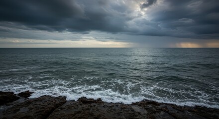 Expansive maritime view of the powerful ocean merging with the distant horizon under a dramatic, cloudy sky, evoking solitude and escape ,escape ,destination ,blue